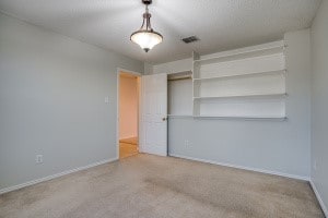 unfurnished bedroom featuring a closet and carpet floors