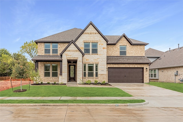 craftsman house featuring a front yard and a garage