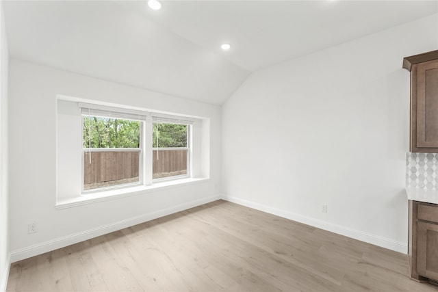 interior space featuring lofted ceiling and light wood-type flooring