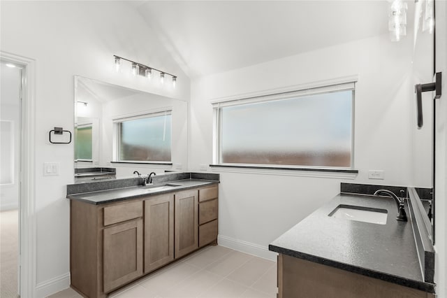 bathroom with vaulted ceiling and vanity