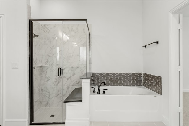 bathroom with tile patterned floors and separate shower and tub