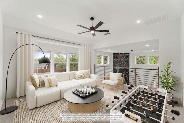 carpeted living room with ceiling fan and a healthy amount of sunlight