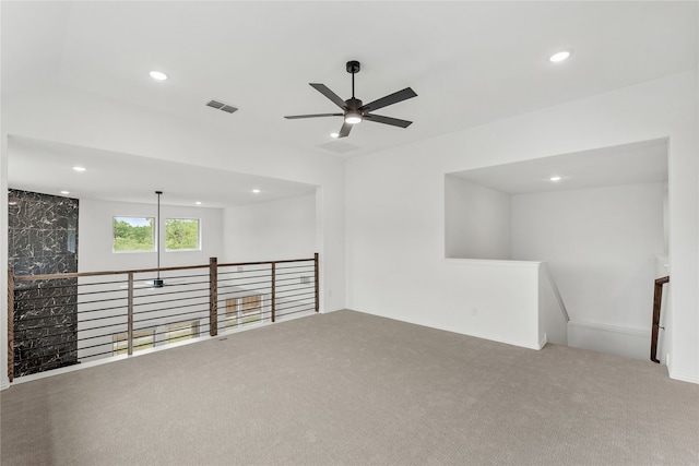 carpeted empty room featuring ceiling fan