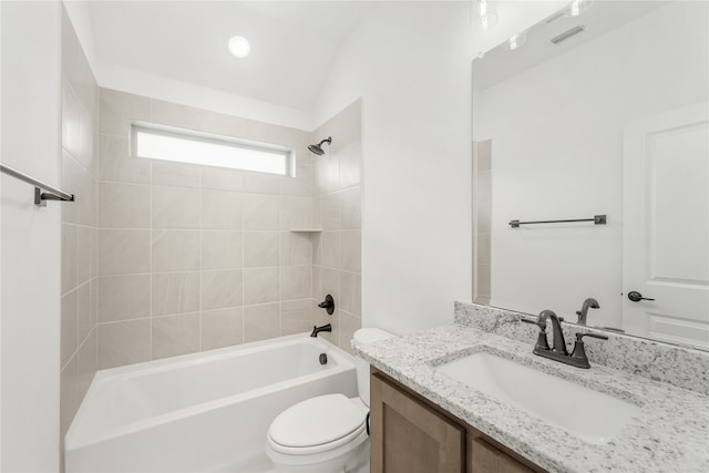 full bathroom with lofted ceiling, tiled shower / bath combo, vanity, and toilet