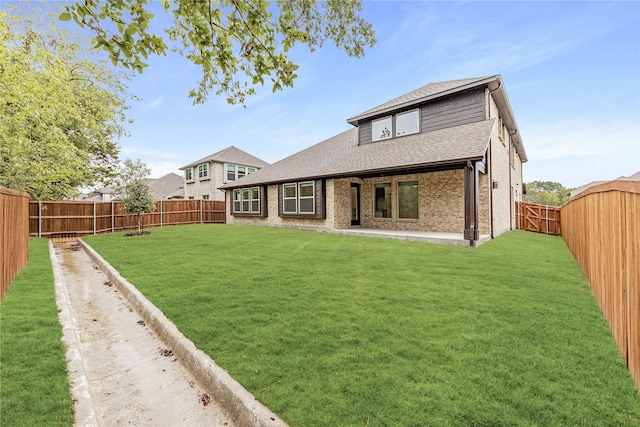 back of property with a lawn and a patio