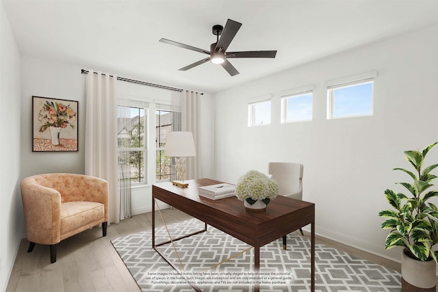 office with a healthy amount of sunlight, ceiling fan, and hardwood / wood-style floors