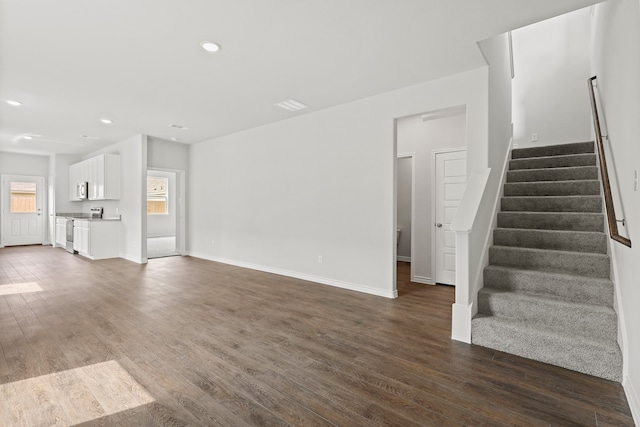 unfurnished living room with dark hardwood / wood-style floors