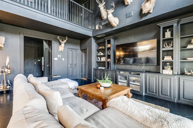 living room featuring a towering ceiling and built in features