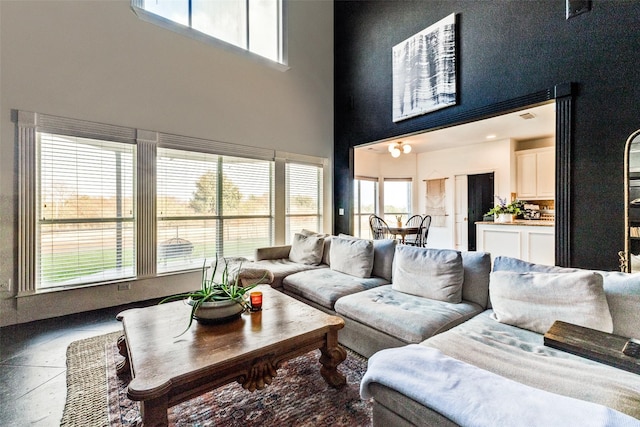 living room featuring a towering ceiling