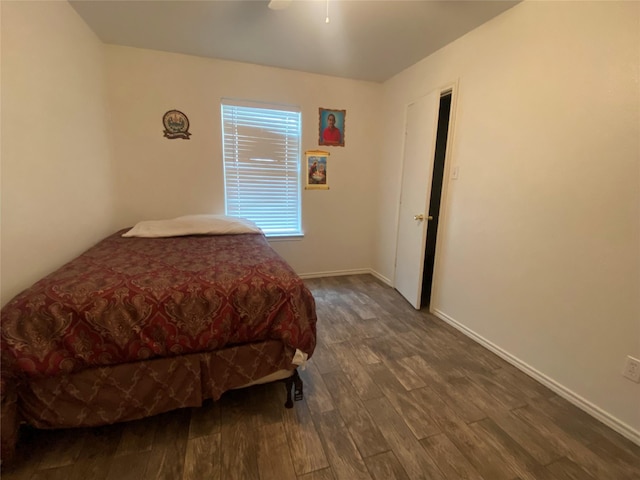 bedroom with ceiling fan and dark hardwood / wood-style floors