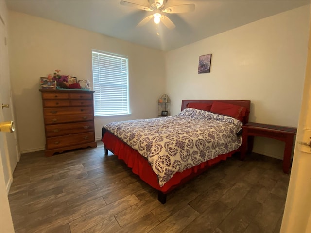 bedroom with ceiling fan and dark hardwood / wood-style floors