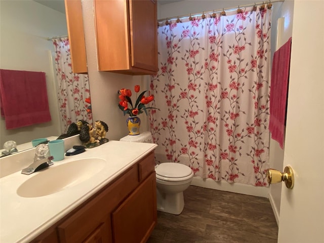 full bathroom featuring hardwood / wood-style floors, vanity, toilet, and shower / bathtub combination with curtain