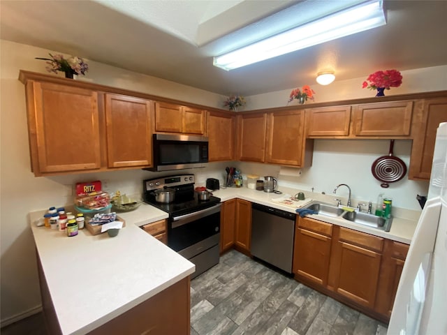 kitchen featuring hardwood / wood-style flooring, sink, and appliances with stainless steel finishes