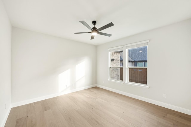 spare room featuring ceiling fan and light hardwood / wood-style flooring