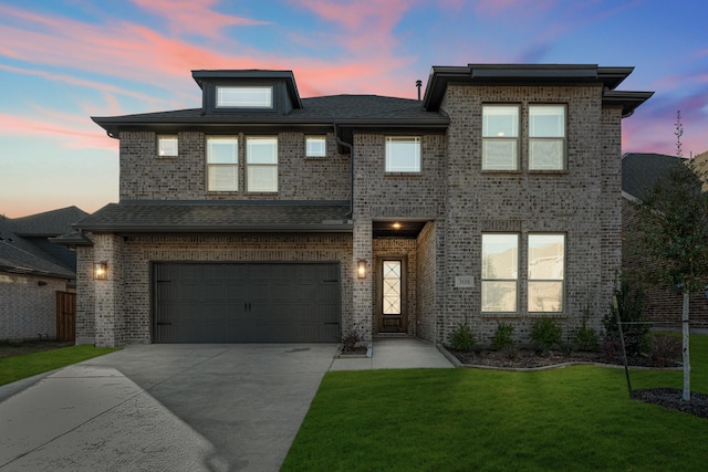 view of front facade featuring a garage and a yard