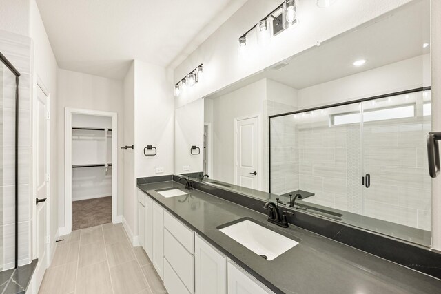 bathroom featuring tile patterned floors, vanity, and an enclosed shower