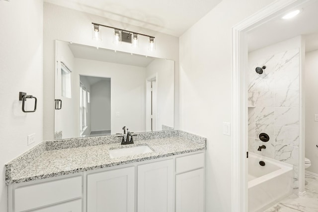 full bathroom with vanity, toilet, and tiled shower / bath combo