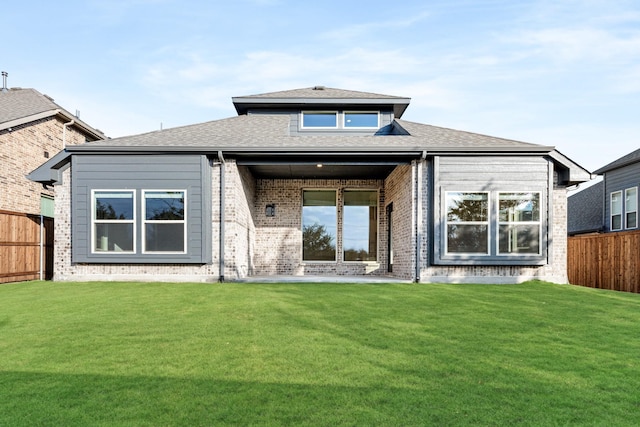 back of house featuring a yard