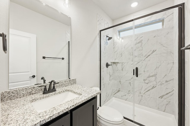 bathroom with vanity, toilet, and walk in shower