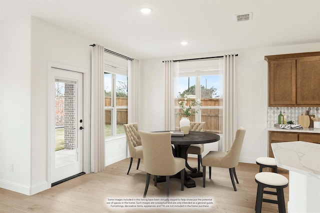 dining area featuring light wood-type flooring