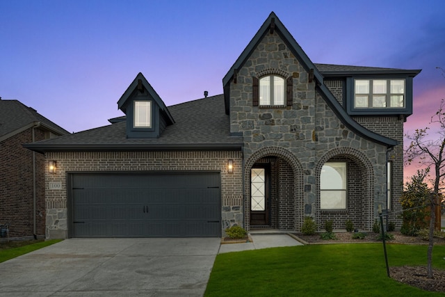 view of front of property with a lawn and a garage