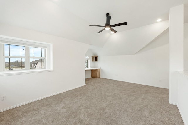 additional living space with ceiling fan, light colored carpet, and lofted ceiling