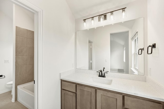 bathroom featuring vanity, toilet, and vaulted ceiling