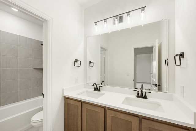 full bathroom with vanity, toilet, and tiled shower / bath combo