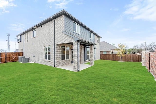 rear view of property featuring a yard, a patio area, and central air condition unit