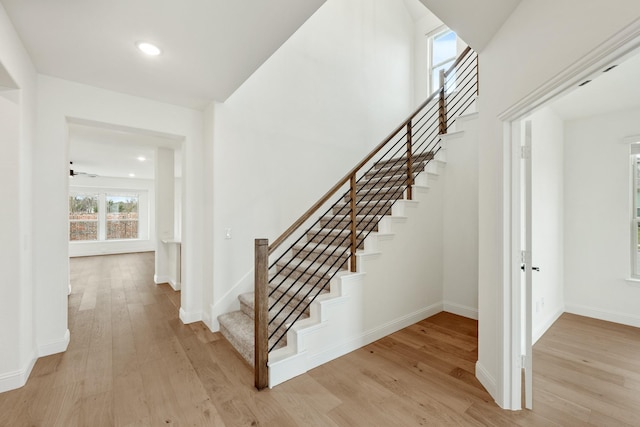 stairs featuring hardwood / wood-style flooring