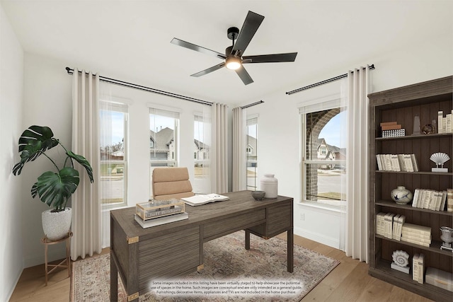 home office with ceiling fan and light wood-type flooring