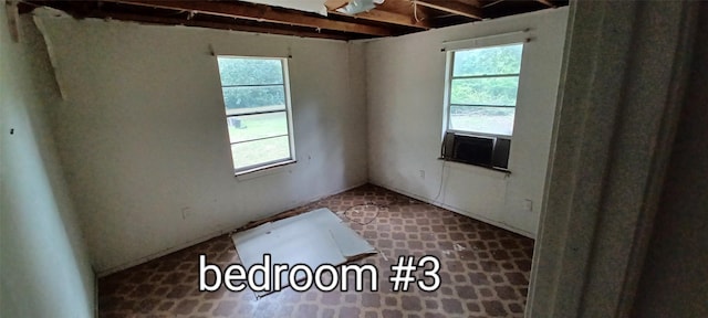 unfurnished room with cooling unit