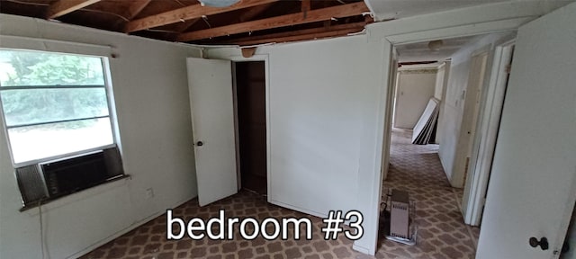 unfurnished bedroom featuring cooling unit