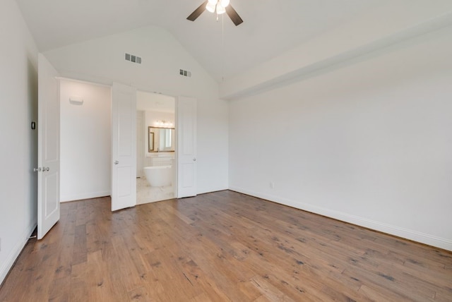 unfurnished bedroom featuring ceiling fan, wood-type flooring, ensuite bathroom, and high vaulted ceiling