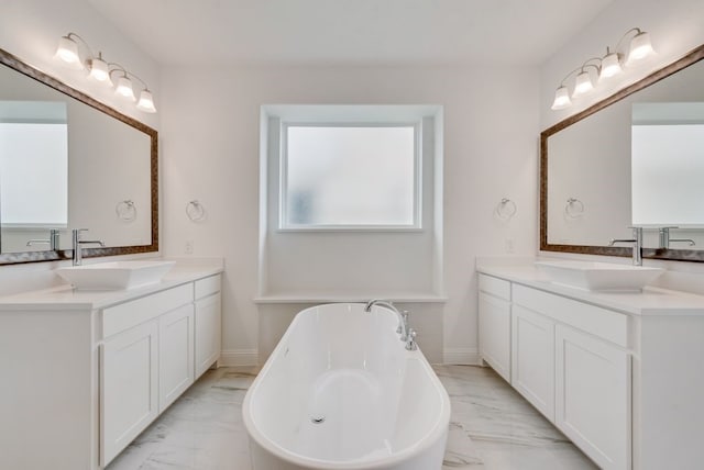 bathroom featuring a tub to relax in and vanity