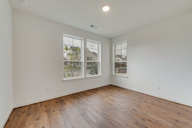 unfurnished room with light wood-type flooring