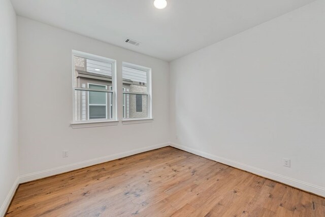 spare room featuring light hardwood / wood-style flooring