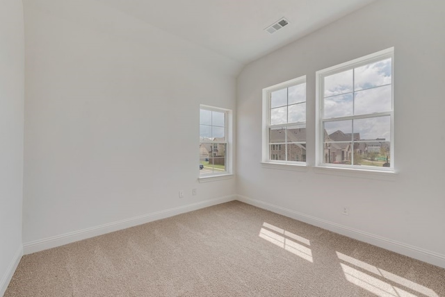 unfurnished room featuring carpet and lofted ceiling