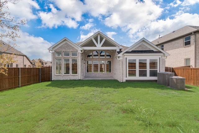 back of property featuring a lawn and central AC unit