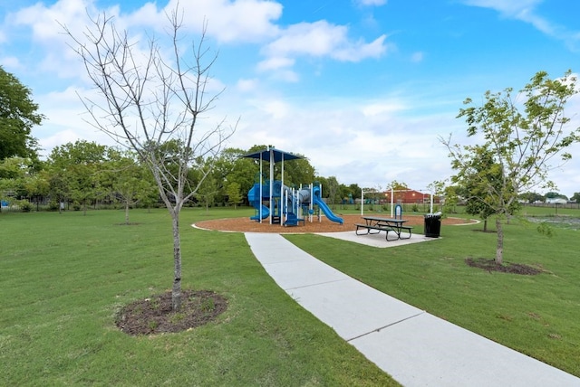 view of playground with a lawn