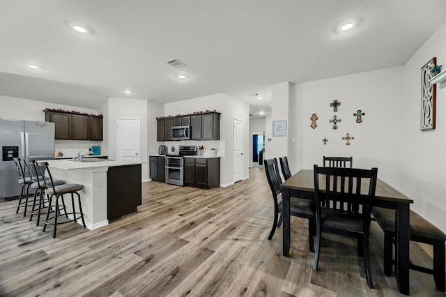 dining space featuring sink and light wood-type flooring