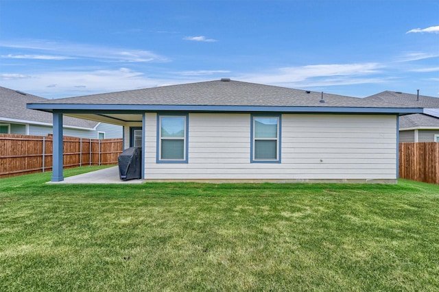 rear view of house with a lawn and a patio