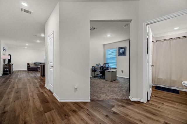 hallway featuring dark hardwood / wood-style flooring