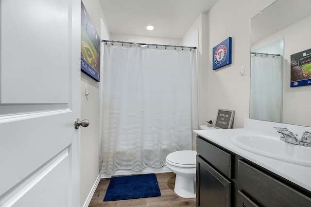 full bathroom with toilet, vanity, shower / tub combo with curtain, and hardwood / wood-style flooring