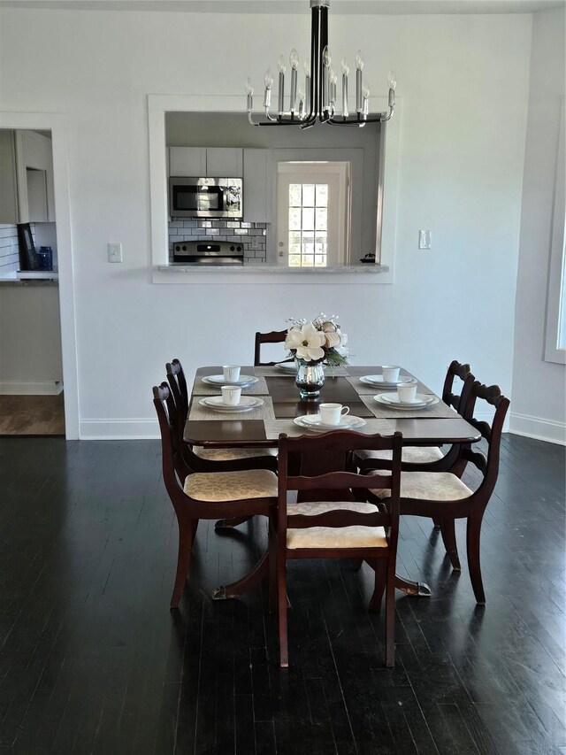 dining room featuring a notable chandelier and dark hardwood / wood-style flooring