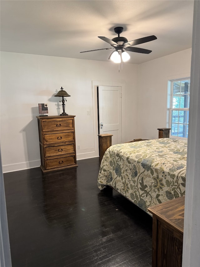 bedroom with ceiling fan and dark hardwood / wood-style flooring