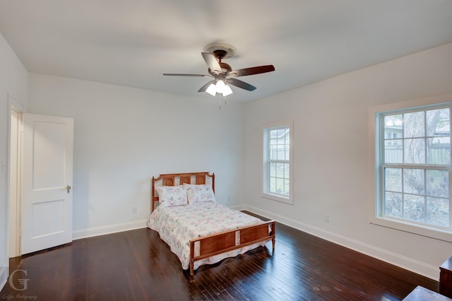 bedroom featuring multiple windows, ceiling fan, and dark hardwood / wood-style flooring