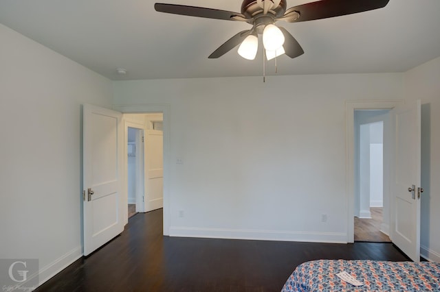 unfurnished bedroom with ceiling fan and dark hardwood / wood-style flooring