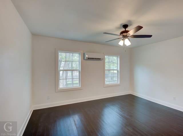 empty room featuring dark wood-type flooring, ceiling fan, a wall unit AC, and a wealth of natural light