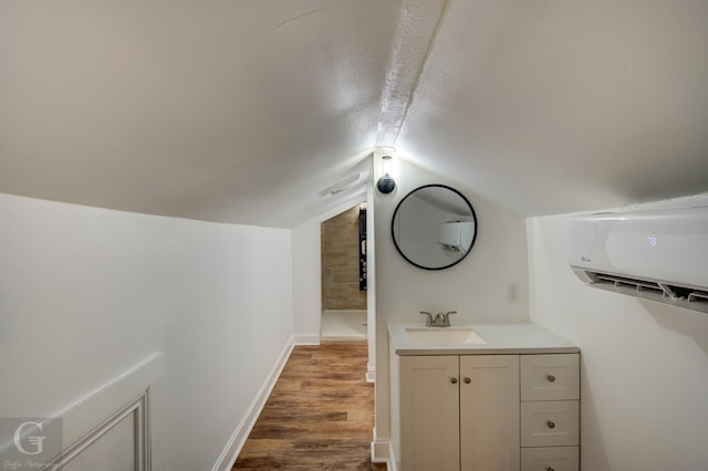 bathroom featuring lofted ceiling, hardwood / wood-style floors, and vanity